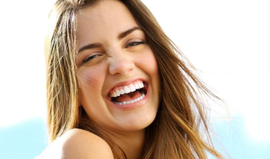 Picture of a smiling woman, showing her happiness with the all-on-six dental treatment she had in Costa Rica.