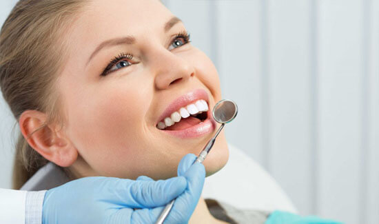 Picture of a woman, smiling at the camera, illustrating her happiness with the bone grafts procedure she had in Costa Rica.