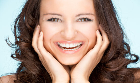 Picture of a woman, smiling at the camera, illustrating her happiness with the dental crowns she had in Costa Rica.