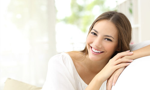 Illustration of a smiling girl, totally relaxed in a white couch.