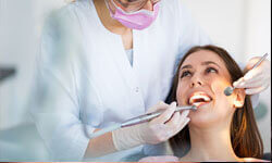 Picture of a smiling woman patient in a dentist chair having a Holistic Dental treatment by Premier Holistic Dental in London.