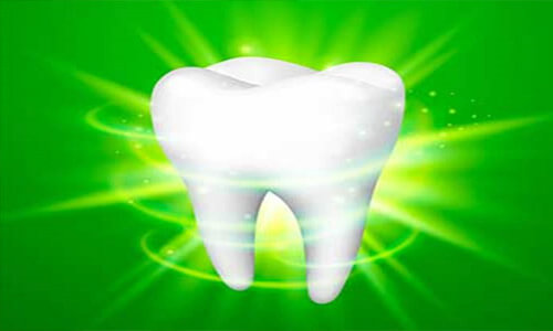 Illustration of a dental tooth depicting a mercury free and fluoride free procedure. The illustration shows a white tooth on a green background.