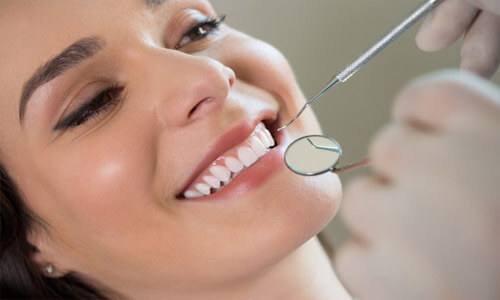 Close-up picture of a smiling young woman with perfect teeth happy with her Holistic ozone therapy treatment at Premier Holistic Dental in Costa Rica.